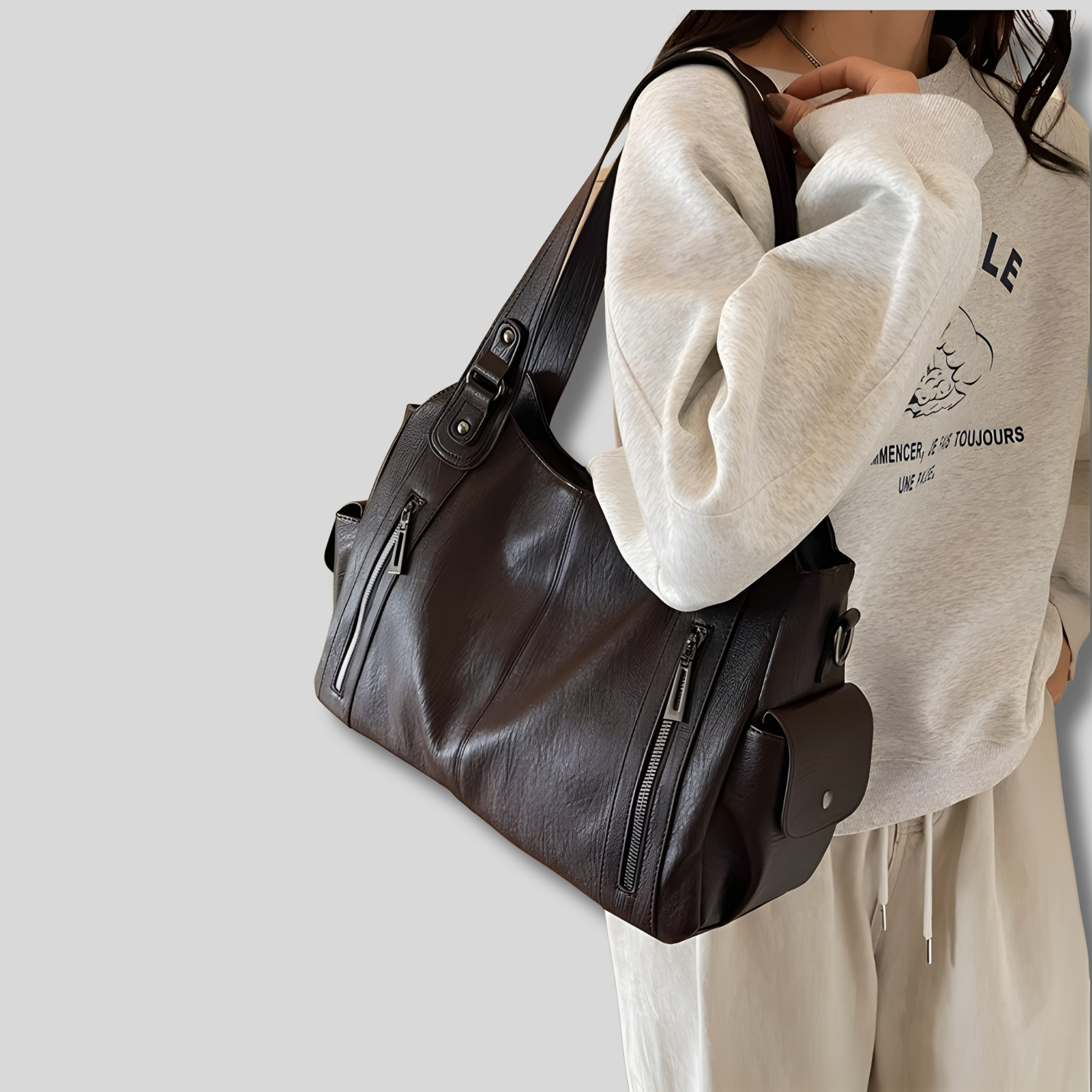 Sac à épaule noir, vue de face, design élégant avec grande capacité et détails zippés modernes