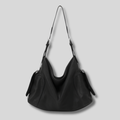 Sac Bandoulière Orélyne en cuir véritable noir avec silhouette souple et poches latérales élégantes.