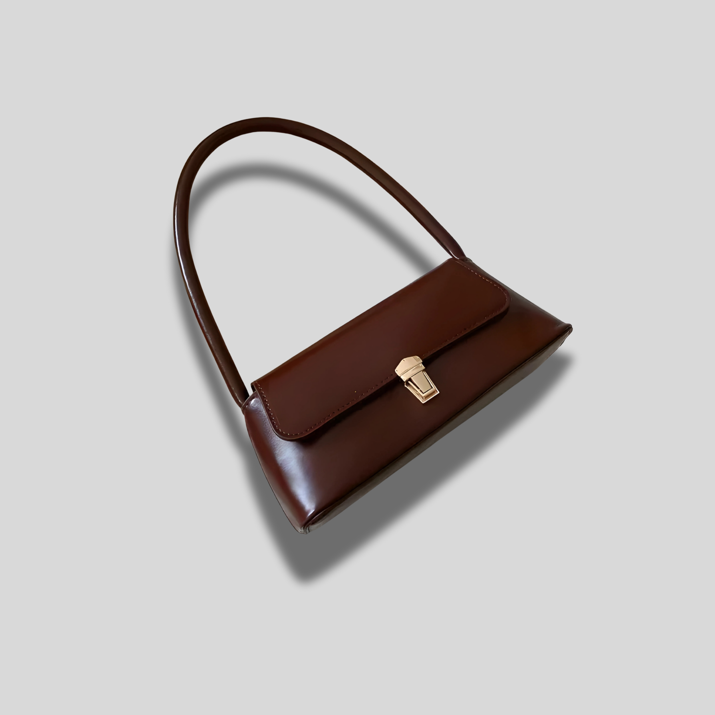 Sac baguette Éloria marron foncé, design minimaliste et élégant, porté main courte pour un style intemporel.