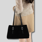 Sac Épaule Liorane noir porté à l'épaule avec look élégant.